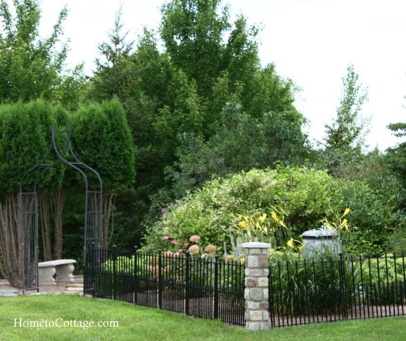 HometoCottage.com front garden with fence and topiary bushes